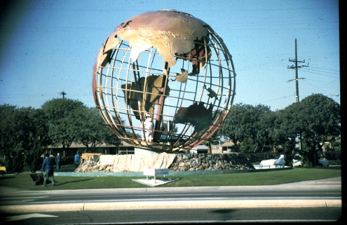 Globe being installed, workers at the bottom of the globe.
